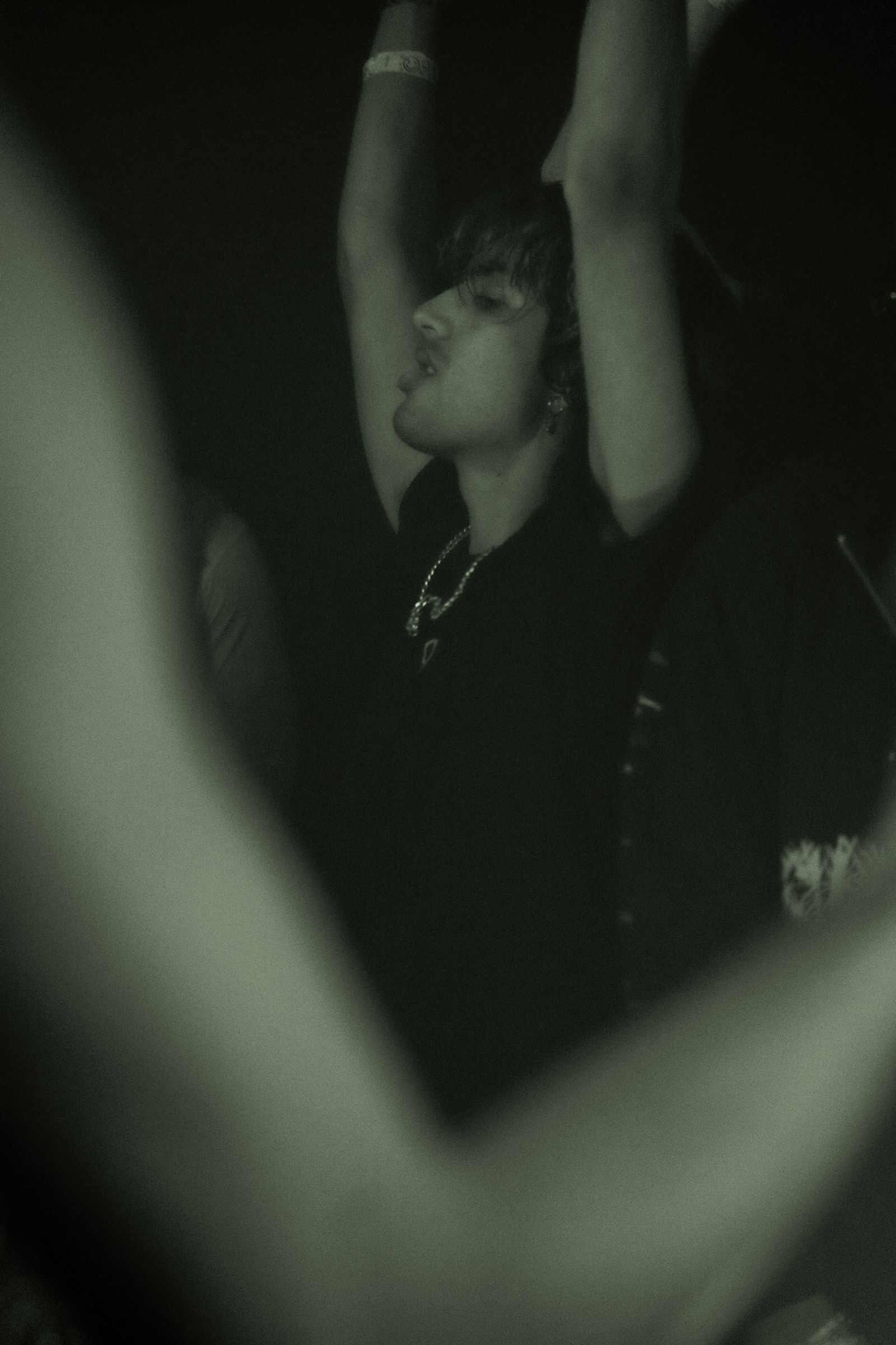 Hands raised on a dancefloor mid-set
